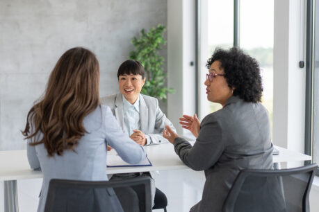 Women agents talking to client in office