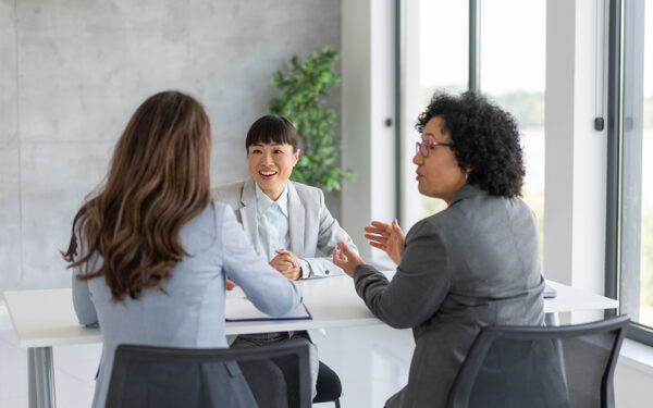 Women agents talking to client in office