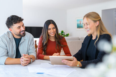 Couple reviewing e-documents with advisor