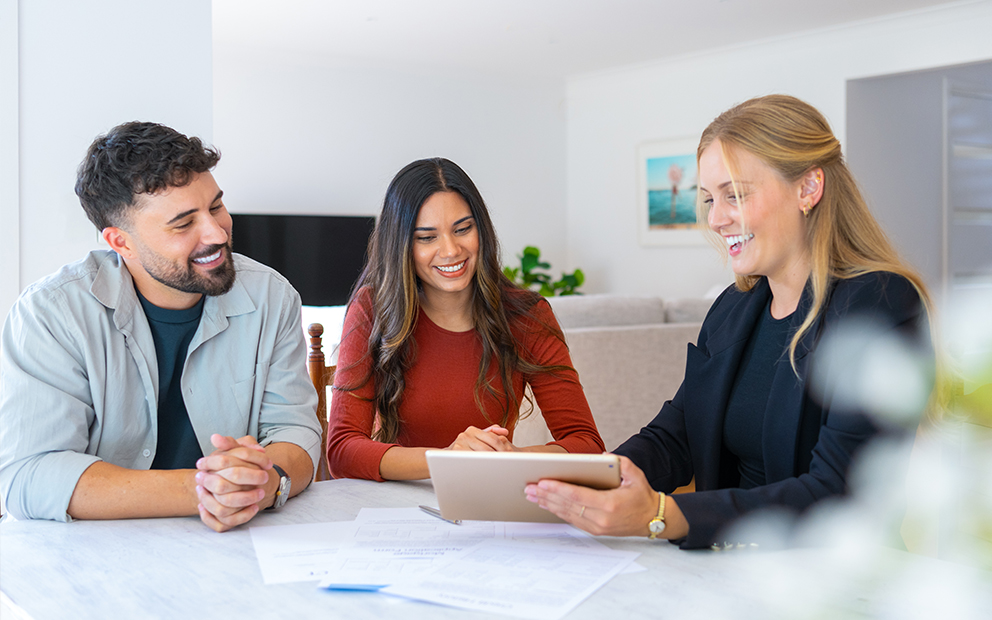 Couple reviewing e-documents with advisor