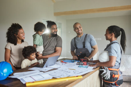 Happy family inside home talking with builder