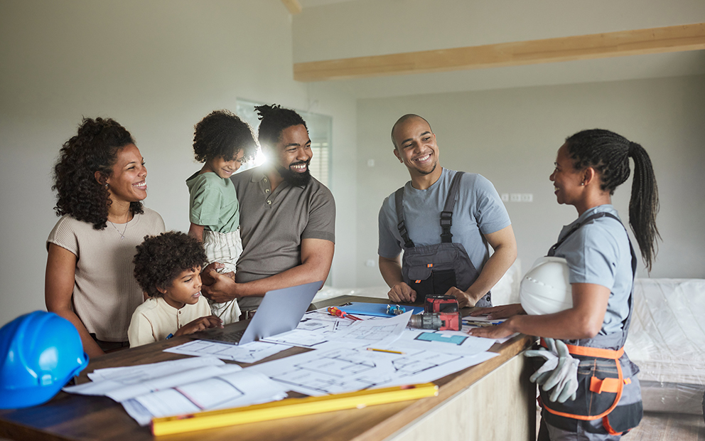 Happy family inside home talking with builder