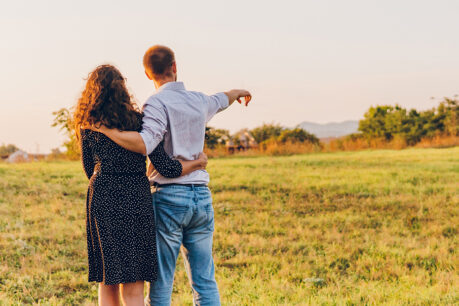 Couple looking out at open land and talking