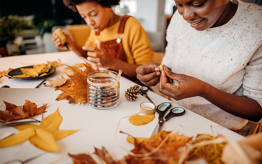 Family making crafts at kitchen table