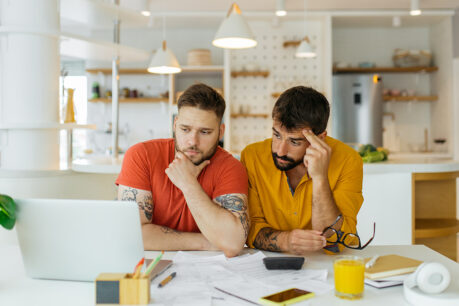 Couple with confused facial expressions as they look at documents