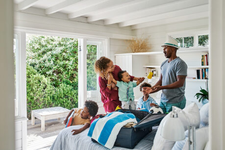 Family unpacking and enjoying vacation home