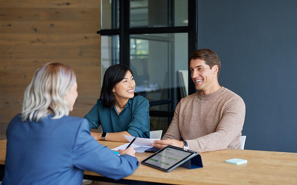 Couple speaking with advisor in office