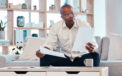 Man reviewing documents and research at home table
