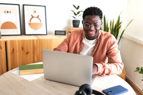 Person researching on laptop while sitting at table