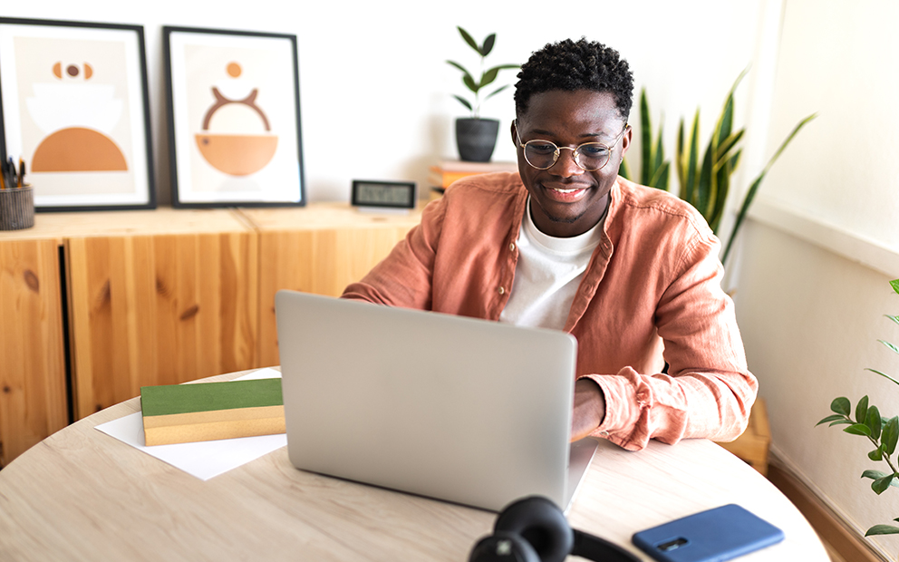 Person researching on laptop while sitting at table