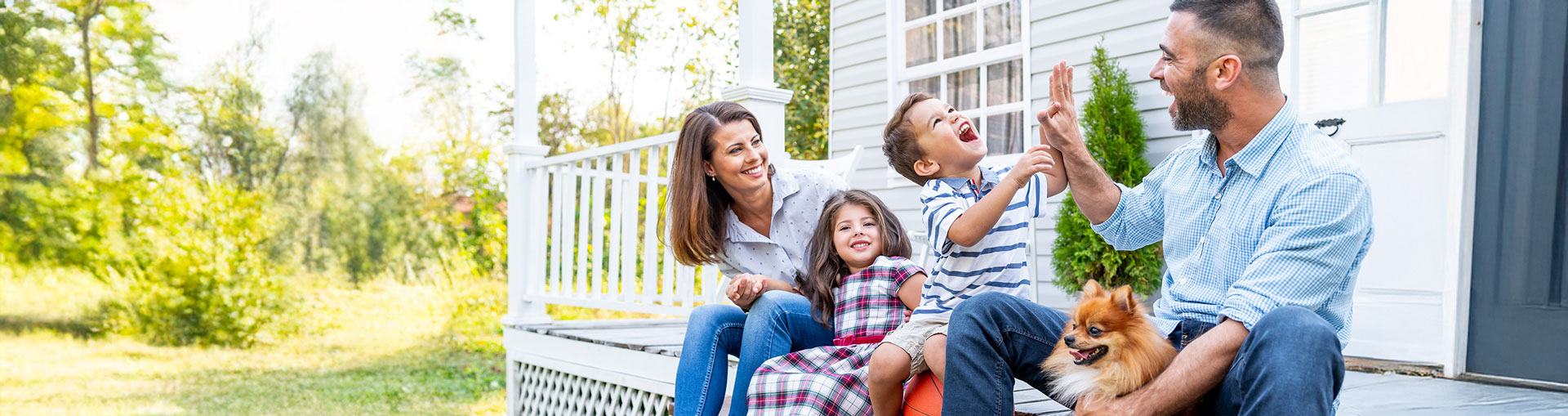 Extremely happy family with tiny dog