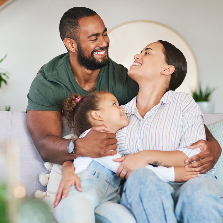 family hugging on couch
