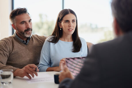 Couple speaking with advisor in office