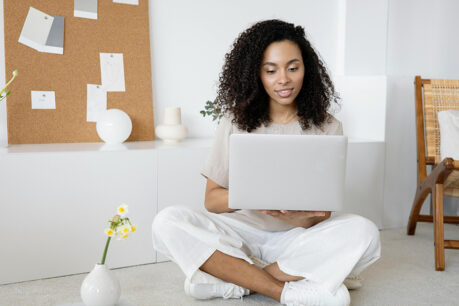 Woman researching on her laptop while sitting at home