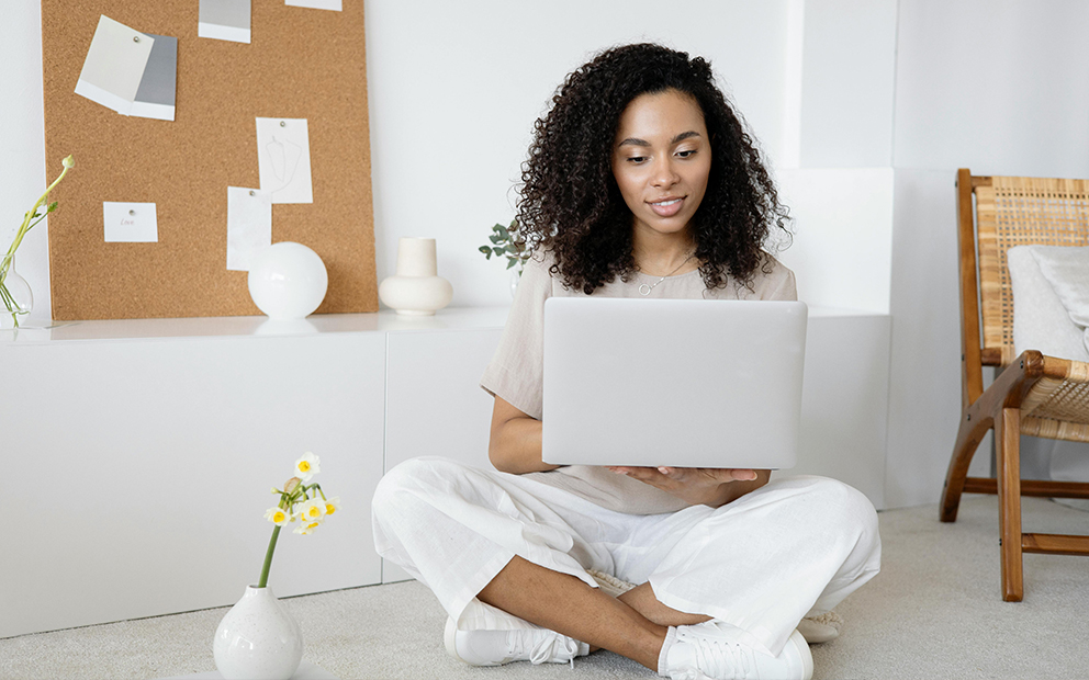 Woman researching on her laptop while sitting at home