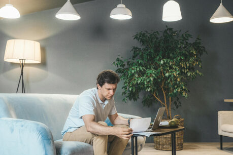 Man researching through documents at home