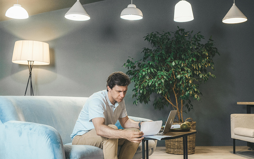 Man researching through documents at home