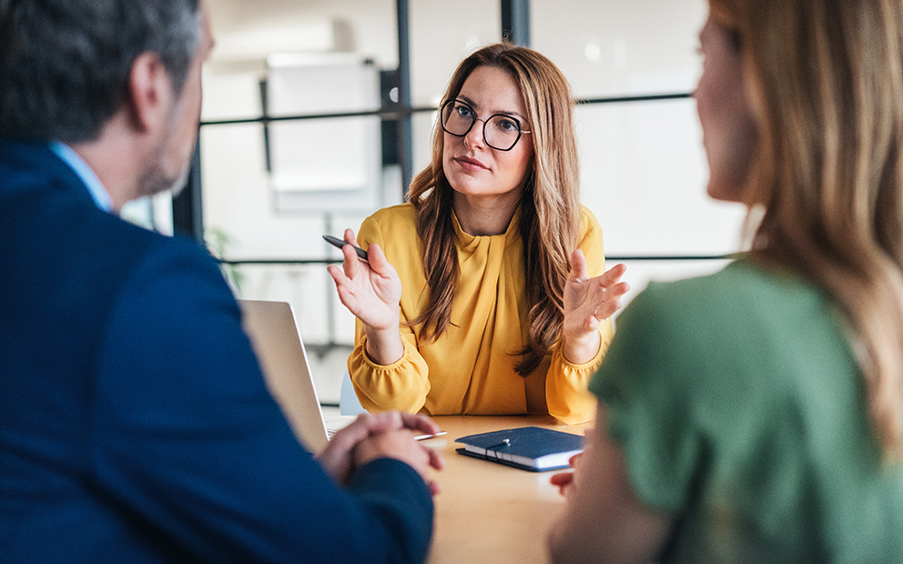 Advisor speaking with couple in office