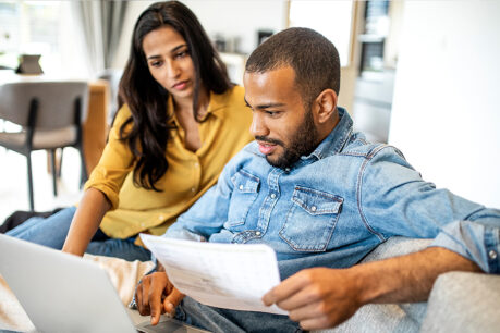 Couple reviewing finance documents at home