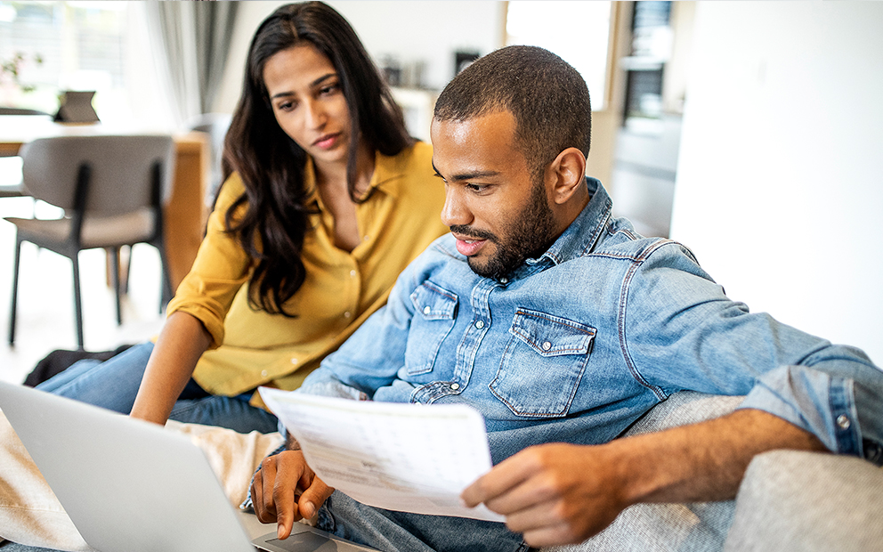 Couple reviewing finance documents at home