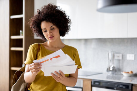 Women looking concerned while reviewing new mail