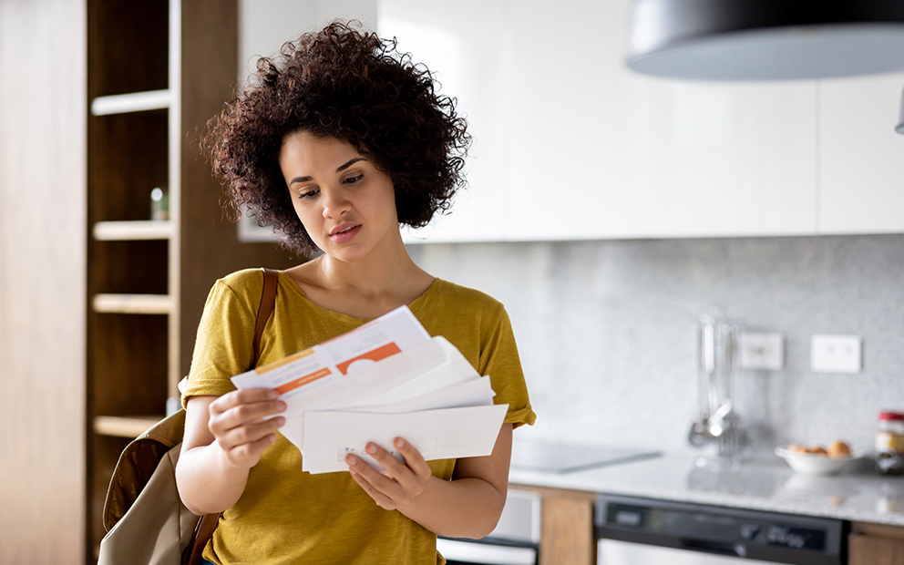 Women looking concerned while reviewing new mail