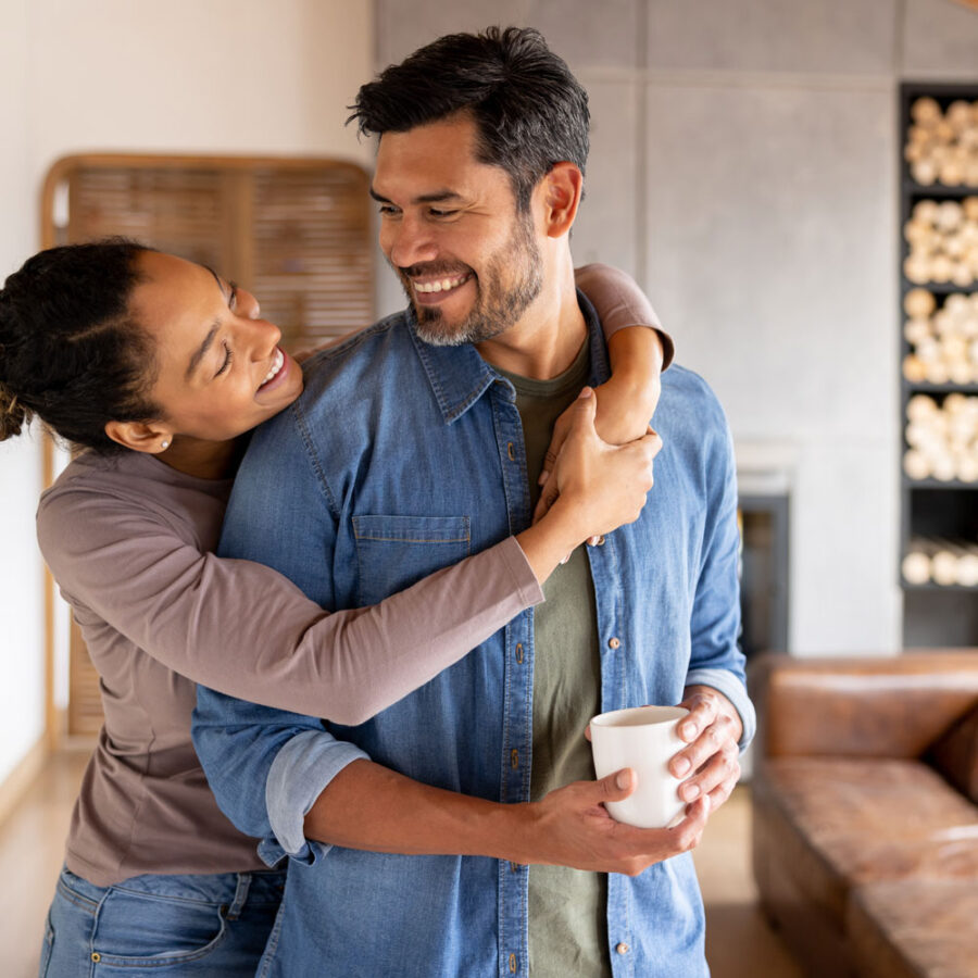 man wincing in pain as coffee burns his palm