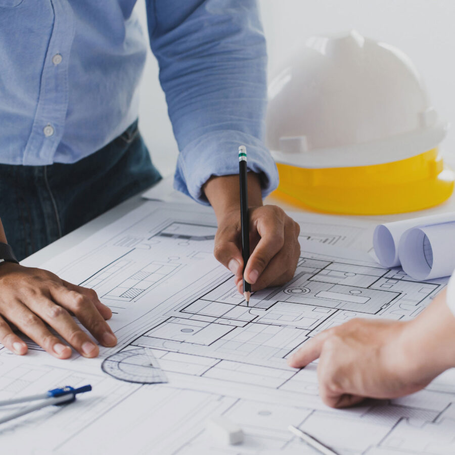 dude with a pencil looking at blueprints