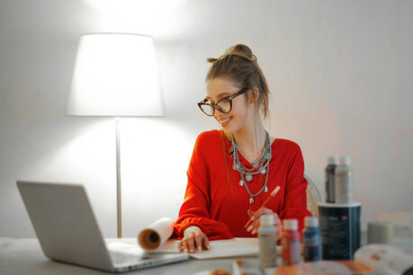 Woman smiling while researching on laptop