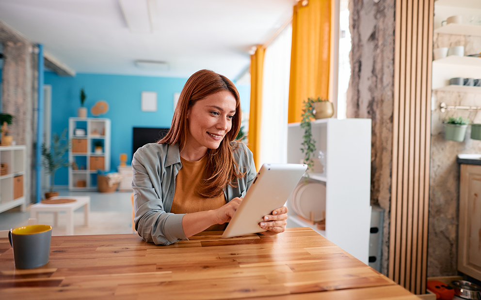 Woman smiling while reviewing info on tablet