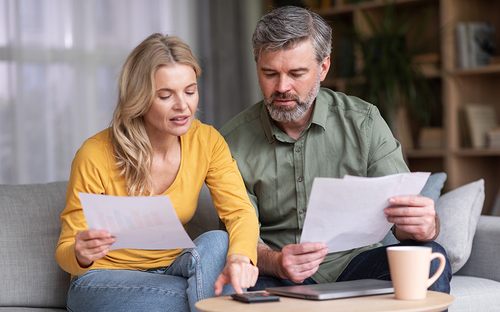 Older couple reviewing documents at home together