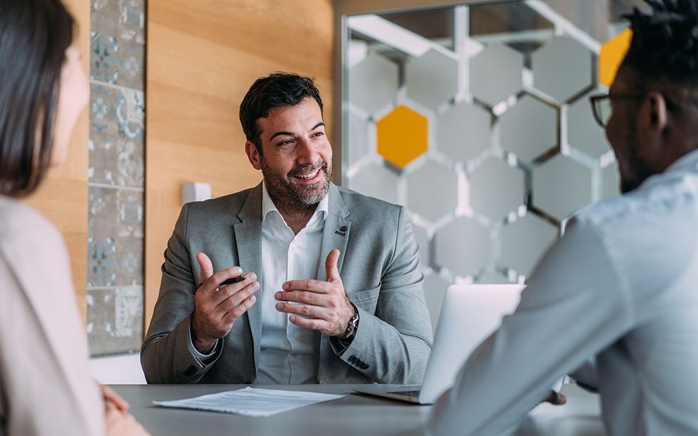 Advisor talking to couple in office