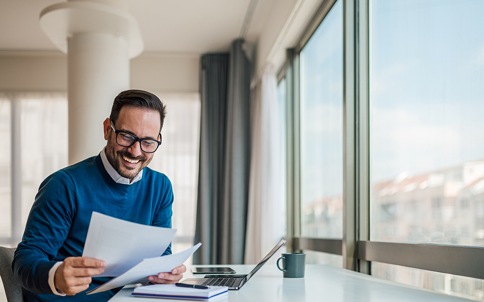 Man reviewing document while at home