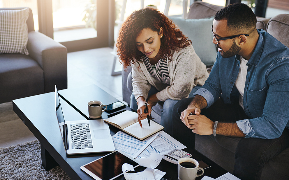 Couple reviewing documents at home together