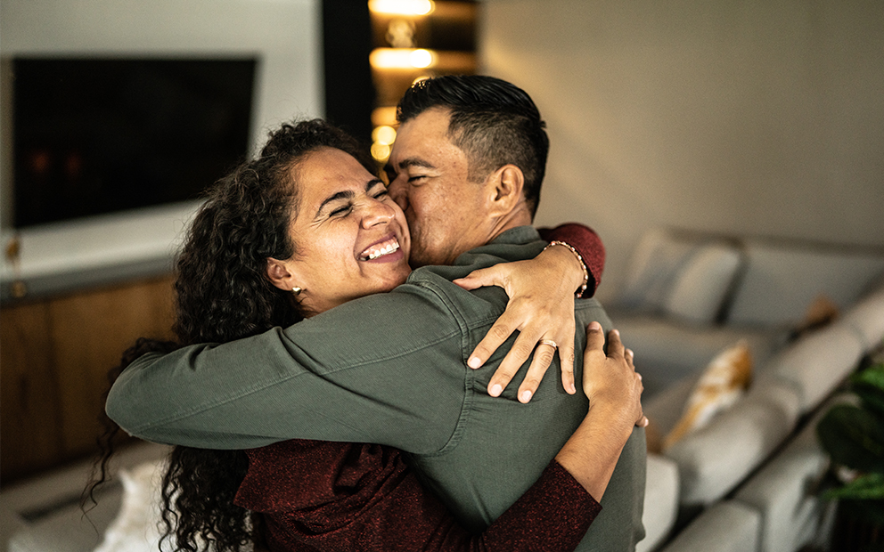 Man and woman couple hugging at home