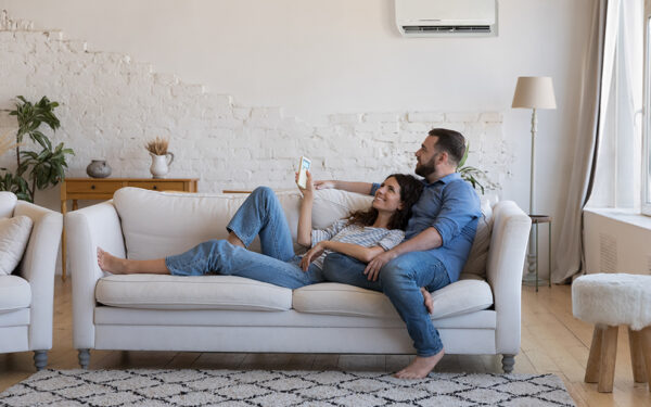 Couple sitting together on couch while looking around their home