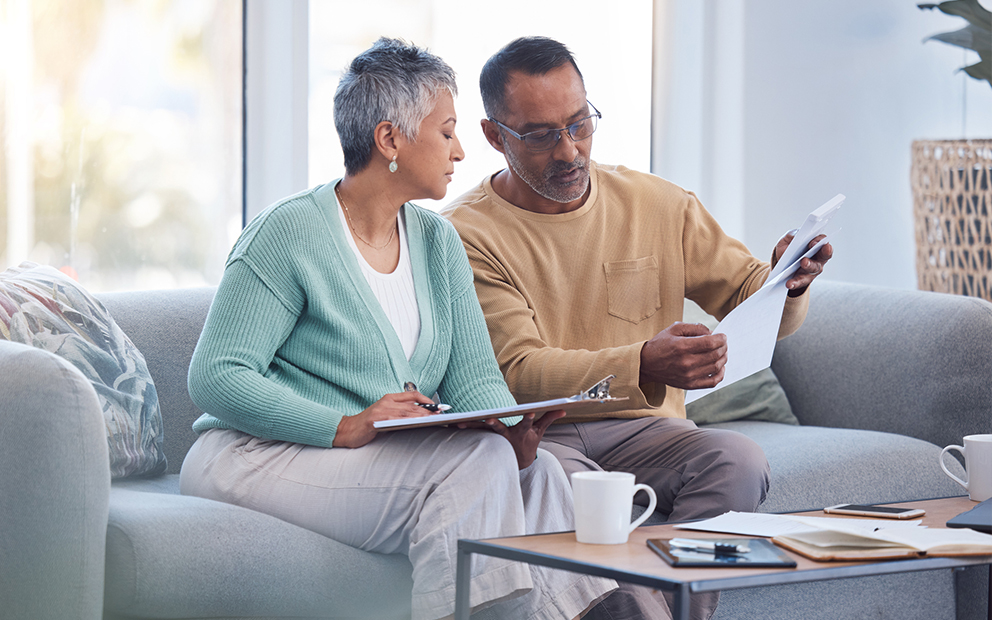 Older couple reviewing documents together at home