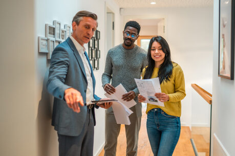 Young couple touring home with realtor