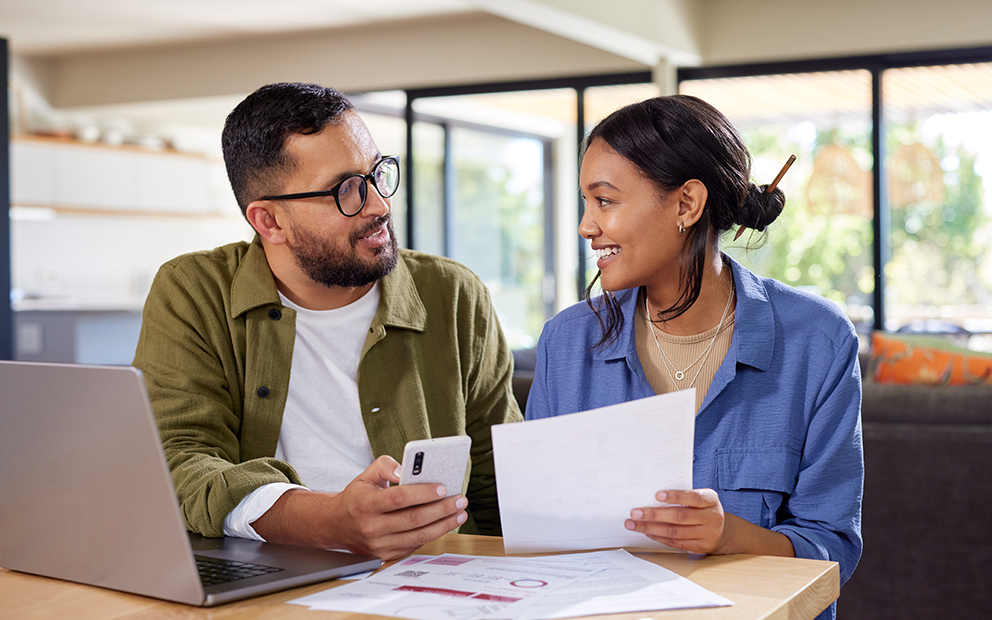 Couple looking over documents and discussing in home
