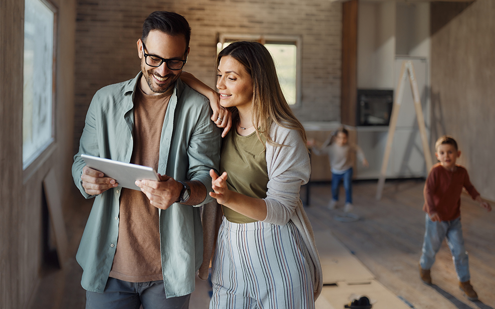 Young couple reviewing information on tablet about using home equity for home improvements