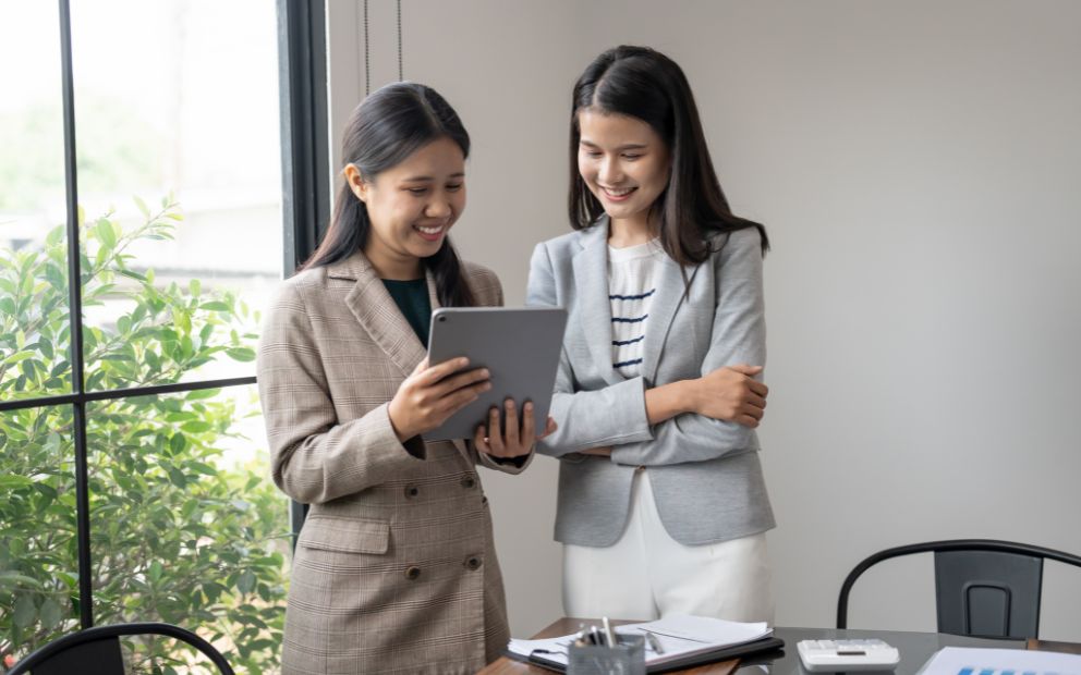 Woman speaking with advisor while looking at tablet together