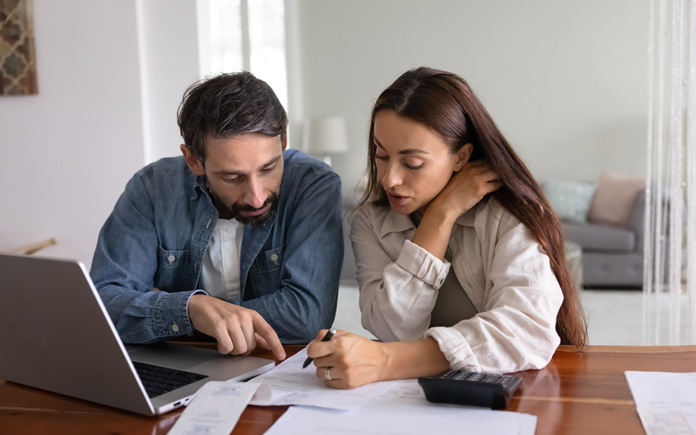Man and woman reviewing documents at home together