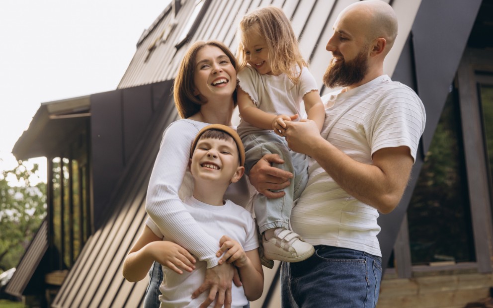 Young family of four enjoying new home made possible with barndominium financing