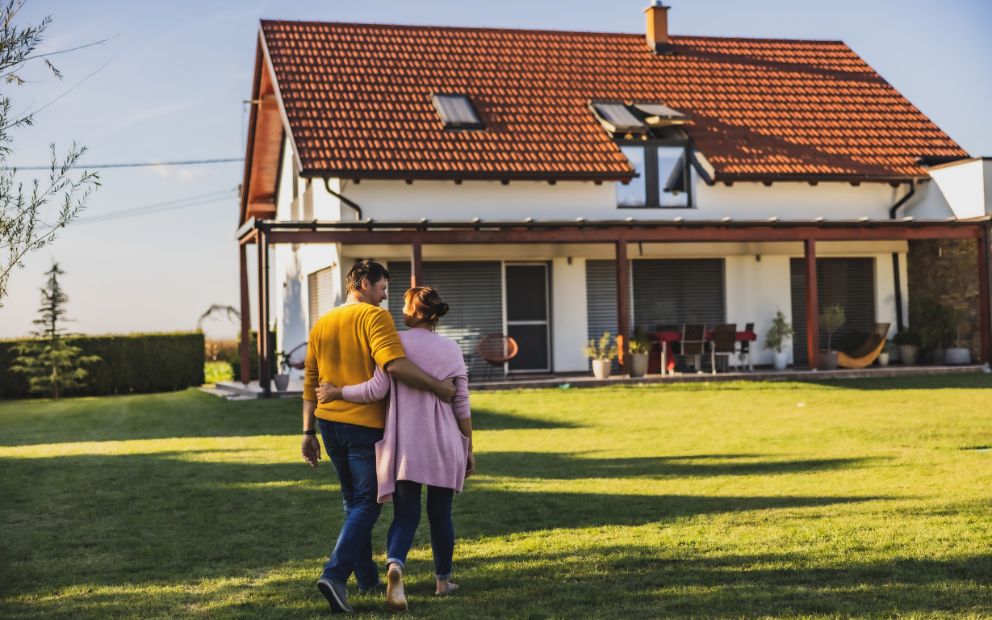 Man and woman couple enjoying their decision of building a home on rural land