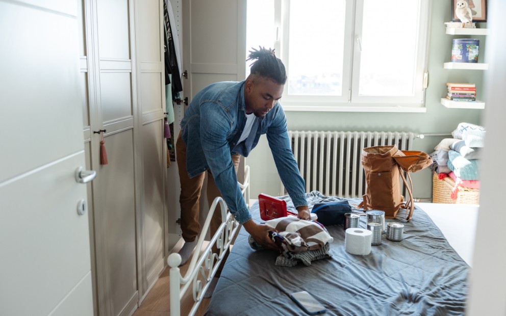 Man packing up items as part of hurricane preparedness for homeowners