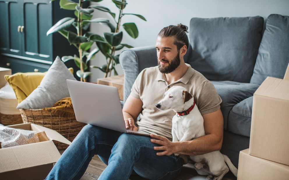 Man and his dog enjoying new living space after using VA loan for HUD home