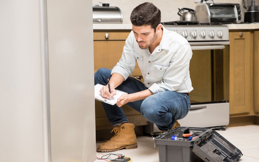 Homeowner inspecting appliances to calculate unexpected home repair costs