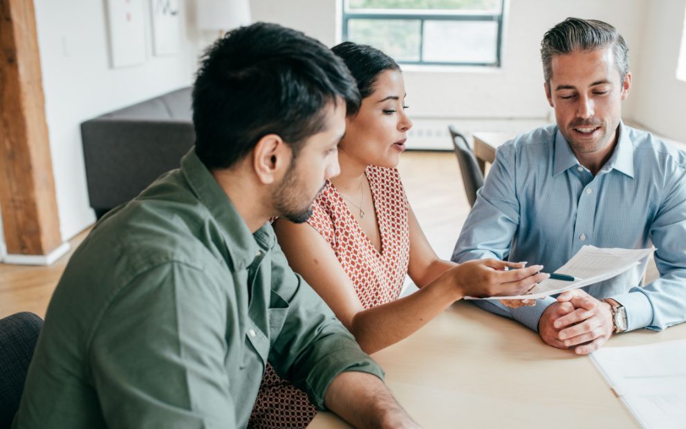 Couple speaking with advisor about construction to permanent loan