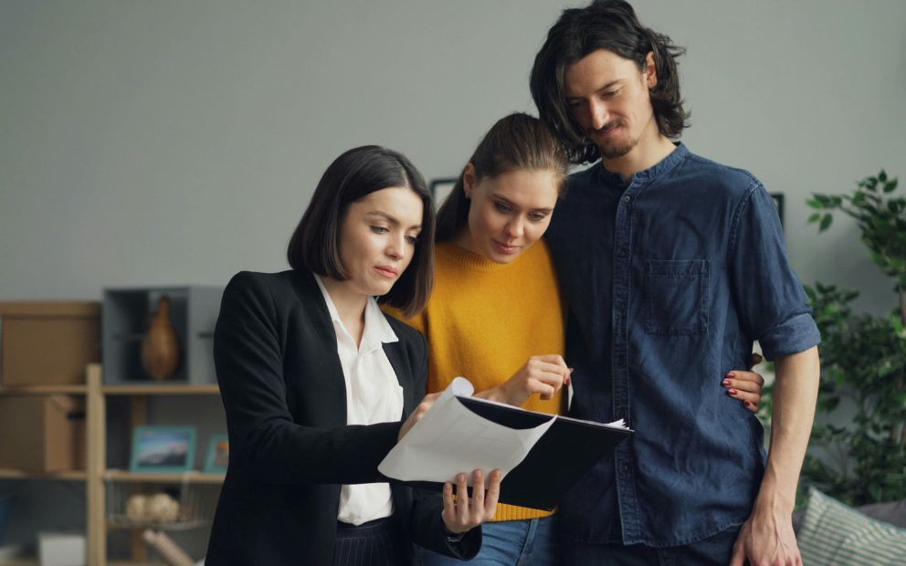 Young couple speaking to loan officer about their mortgage rate lock options