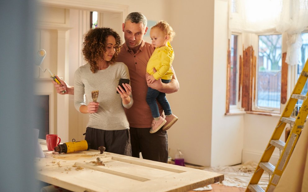 Young family of three enjoying their decision to utilize a FHA 203(k) loan